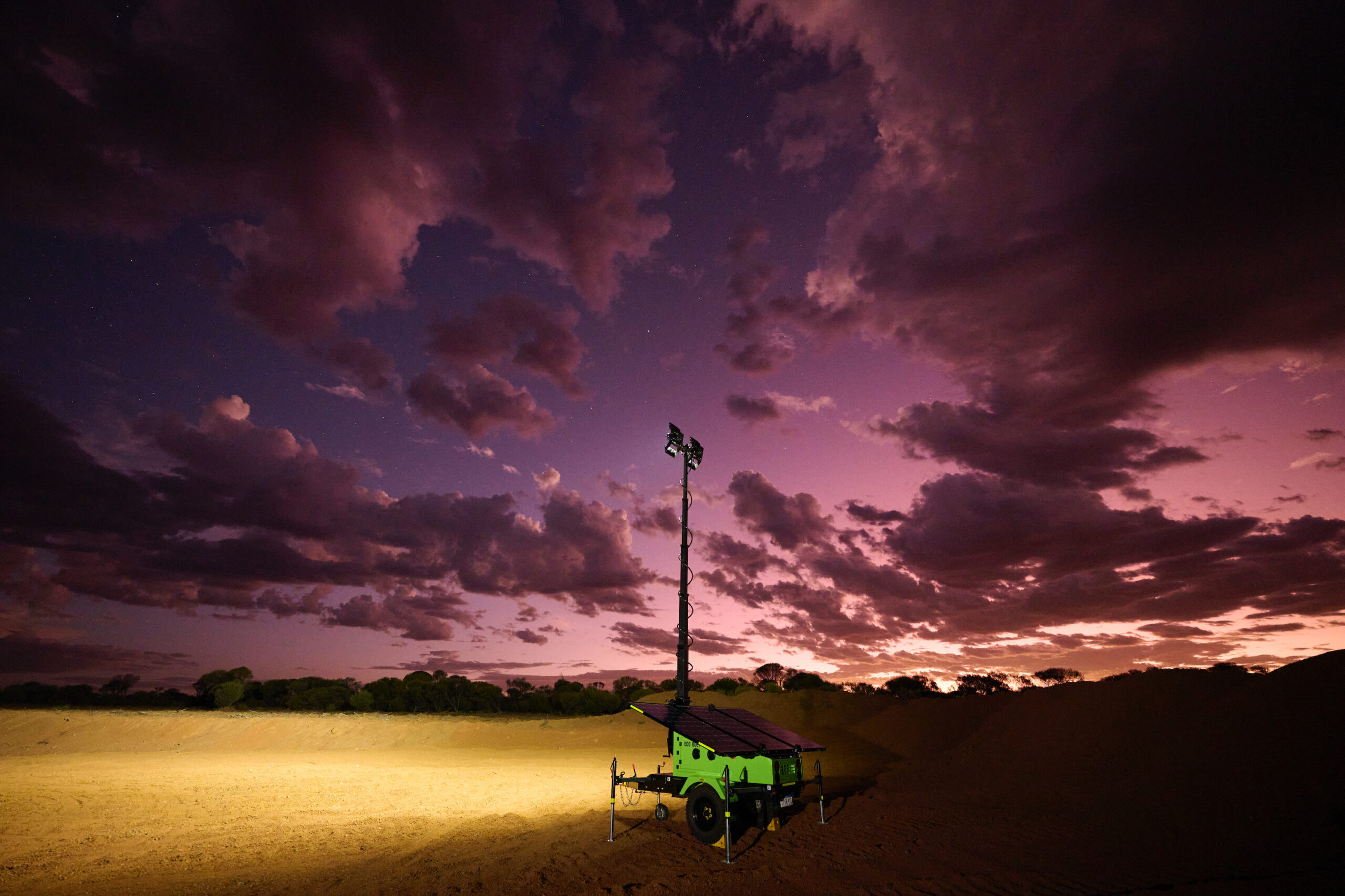 An EcoQuip Mobile Solar Light Tower at night.