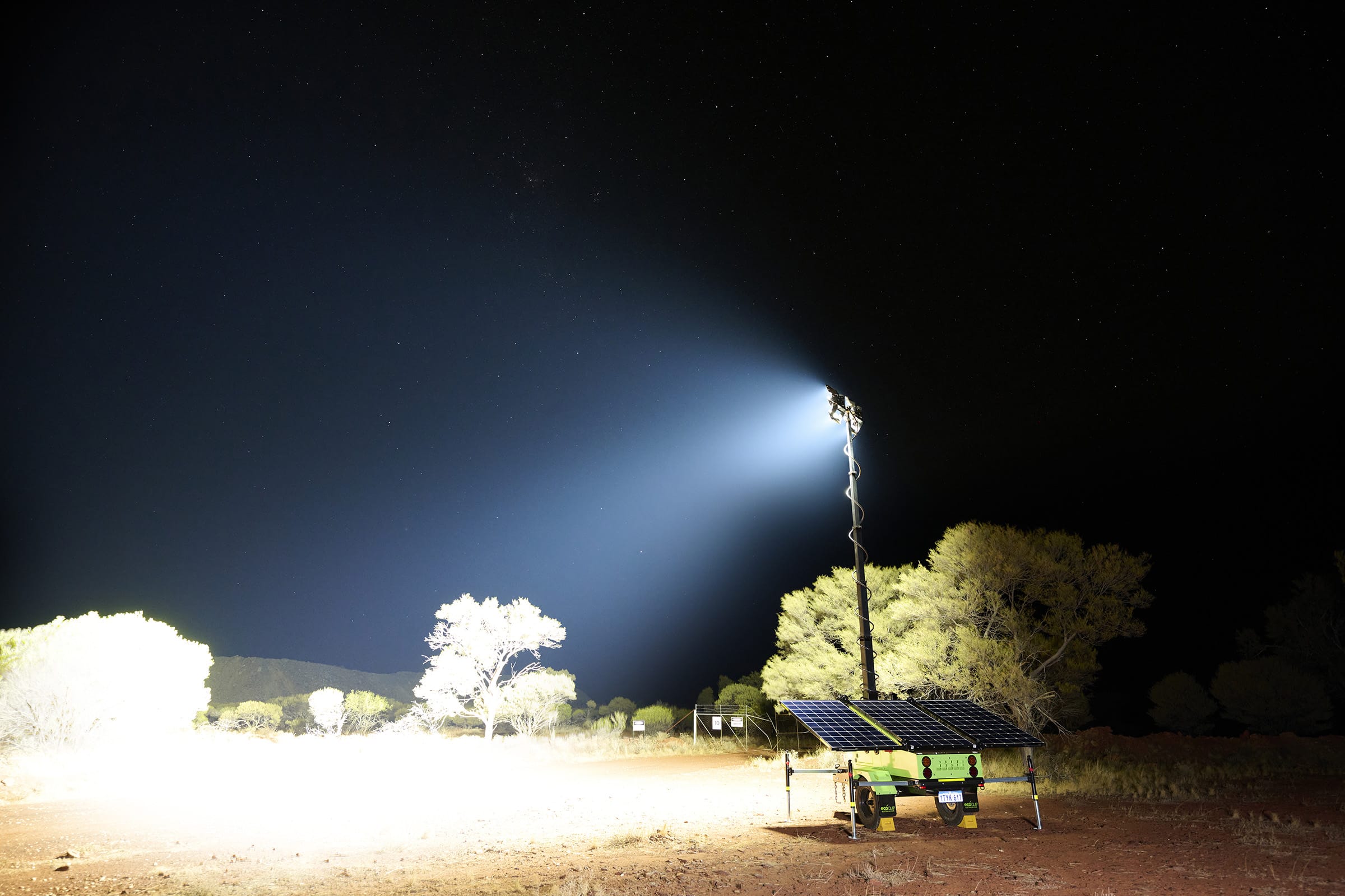 An EcoQuipmobile solar light tower illuminating a mine site.